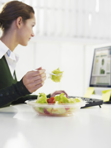 Woman eating a salad researching direct primary care