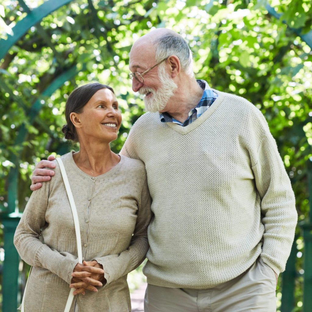 Senior couple enjoying a walk after meeting with their direct primary care doctor